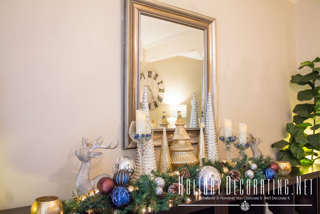 Dining Room Side Table Decorated In Navy, Silver, And Gold.